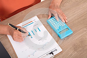 Looking down and shooting financial practitioners working through documents and calculators