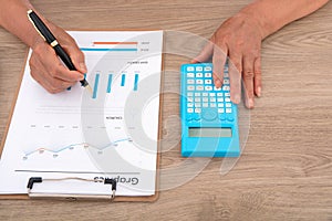 Looking down and shooting financial practitioners working through documents and calculators