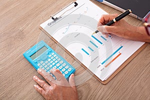 Looking down and shooting financial practitioners working through documents and calculators