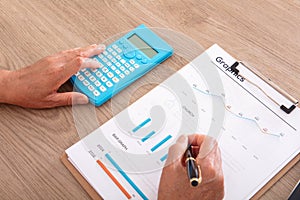 Looking down and shooting financial practitioners working through documents and calculators