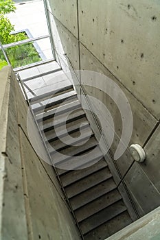 Looking down on staircase with metal handrails inside of commercial building