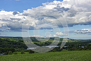 Looking down to Loch Clunie from the surrounding Hills with scattered Trees amongst the farmland