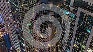 Looking down view perspective on night highlighted luxury Dubai Marina skyscrapers night timelapse, Dubai, United Arab