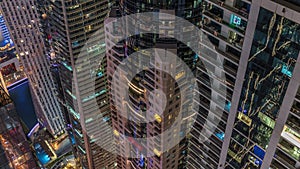 Looking down view perspective on night highlighted luxury Dubai Marina skyscrapers night timelapse, Dubai, United Arab