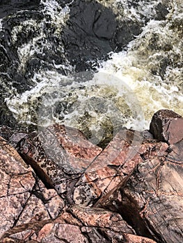 Looking down at water rapids by rocks