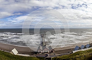 Looking down at waves crashing onto the beach at Saltburn-by-the-Sea in North Yorkshire