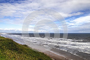 Looking down at waves crashing onto the beach at Saltburn-by-the-Sea in North Yorkshire