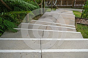 Looking down on white anti-slip step nosing lines on concrete steps photo