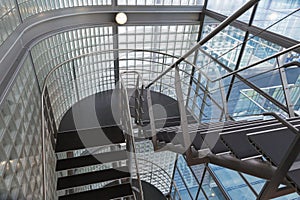 Looking downwards in an open stairwell of a modern building photo