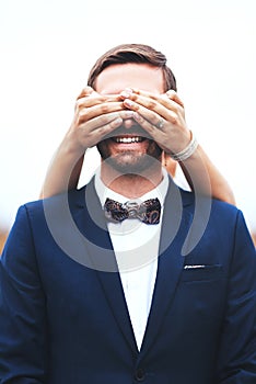 Looking forward to a life full of surprises with you. a happy bridegroom getting his eyes covered by his bride on their