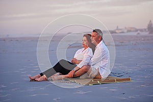 Looking forward to a rest filled retirement. a mature couple relaxing together on the beach.