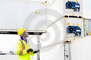 Looking forword. Foreman using laptop computer in the port of loading goods. Foreman showing thumbs up on Forklifts in the