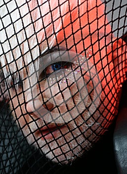 Looking freaky. BDSM fashion accessory. Heterosexual man with male makeup. Transgender man cover face with fishnet. Male