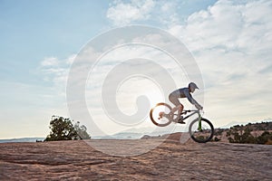 Looking for a genuine adrenaline-pumping experience. a young man out mountain biking during the day.