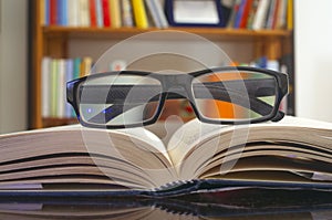 Looking glasses on an open book