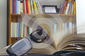 Looking glasses on an open book