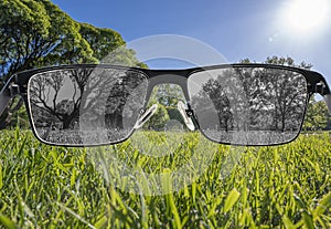 Looking through glasses to bleach nature landscape. Color blindness. World perception during depression. Medical condition. Health