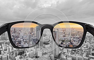 Looking through glasses to city view in sunset. Color blindness glasses, Smart glasses technology