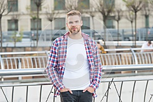 Looking good. student walk in city. handsome young man wear checkered shirt. casual dressed male fashion model posing