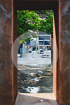 Looking through a hole in a piece of urban art in downtown Winnipeg, Manitoba, Canada