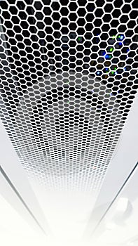 Looking through honeycomb pattern doors inside modern big data server rack in the data center with network servers hardware