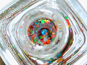 Looking into nail polish with hexagon colorful glitter