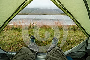 Looking at the nature from a tent in wild, while hiking in Iceland