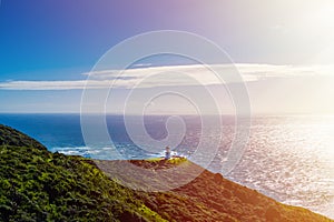 Looking at the northernmost point of New Zealand, the tip of Cape Reinga with the Lighthouse basking in the afternoon