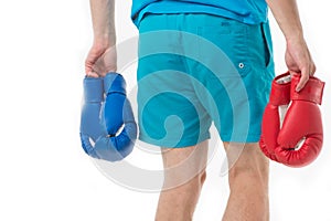 Looking for opponent. Man in shorts carries two pairs boxing gloves rear view isolated white background. Equipment