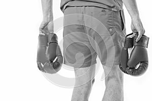 Looking for opponent. Man in shorts carries two pairs boxing gloves rear view isolated white background. Equipment