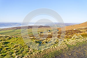 Looking out across the fields and valleys of the Derbyshire countryside on a cloudless winter morning.