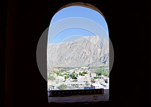 Looking out from an Oman fortress to the mountains and city below which it historically protected.