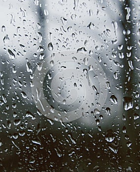 Looking out of a window covered with rain drops.