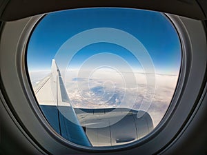 Looking out the window of a jet airplane over the wing