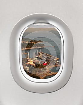 Looking out the window of a plane to the city of Baska Voda