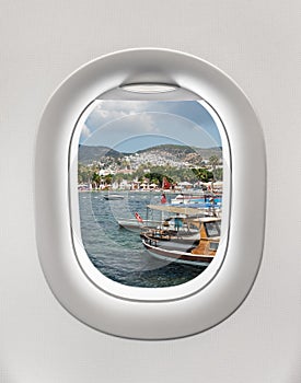 Looking out the window of a plane to the harbor in Bodrum