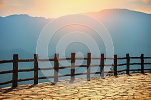 Looking over the mountains in front of the railing