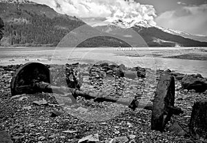 Looking over a relic of wheels and axel at the Gastineau Channel, on Sandy Beach, Alaska