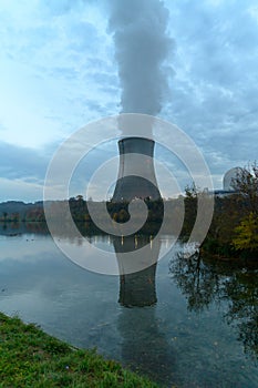 Looking over a river at an atomic reactor cooling tower