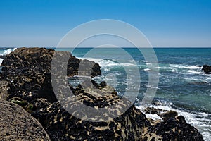 Looking over rocks towards blue Atlantic ocean in Portugal