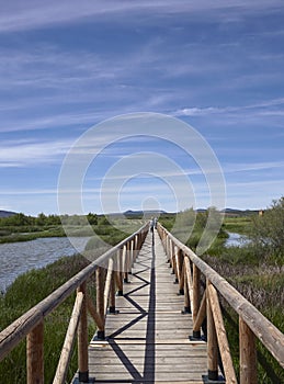 Looking over the straight wooden Footbridge at the Fuente de Piedra Nature Park and Salt Water Lagoon.