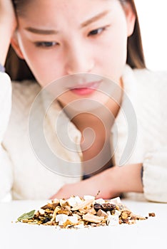 Looking at a pile of Chinese herbs.