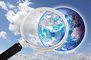 Looking at planet earth towards USA - Concept seen through a magnifying glass with elements furnished by NASA