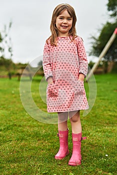 Looking pretty and cute in pink. Portrait of an adorable little girl having fun outdoors.