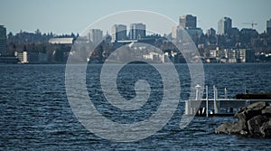 Looking at Seattle downtown cityscape across Washington lake from Medina Beach