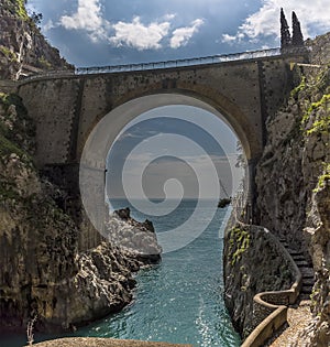 Looking seaward through the arched bridge at Fiordo di Furore on the Amalfi Coast, Italy