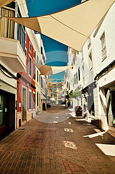 Looking for shadow. Mahon town street. Minorca, Spain