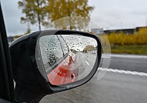 looking through side mirror on a red car