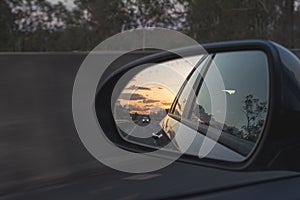 Looking through a side mirrors with a car in it