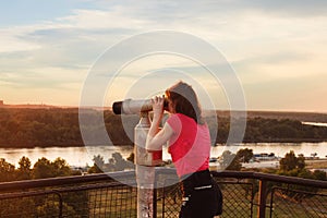 Looking through sightseeing binoculars